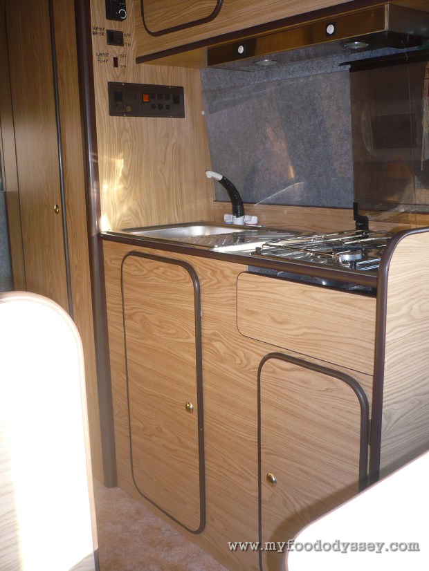 Opposite the counter are the sink and cooker.