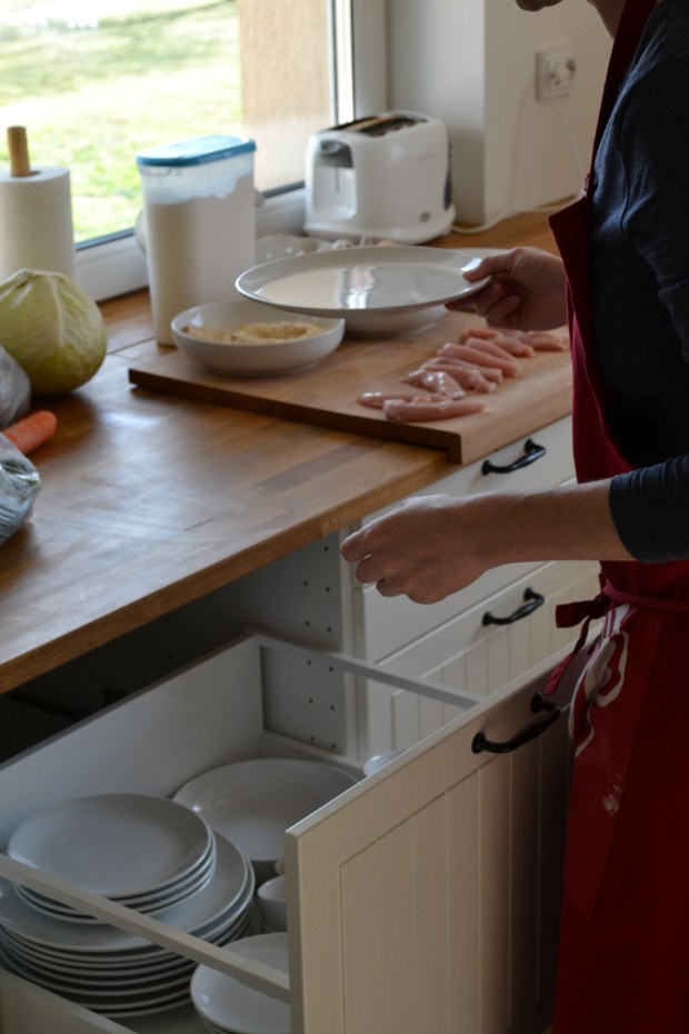 Making chicken goujons.  Featured IKEA items include METOD drawer with MAXIMERA interior, HAMMARP worktop, LAMPLING cutting board, JAMKA storage box and VINTER 2014 apron.
